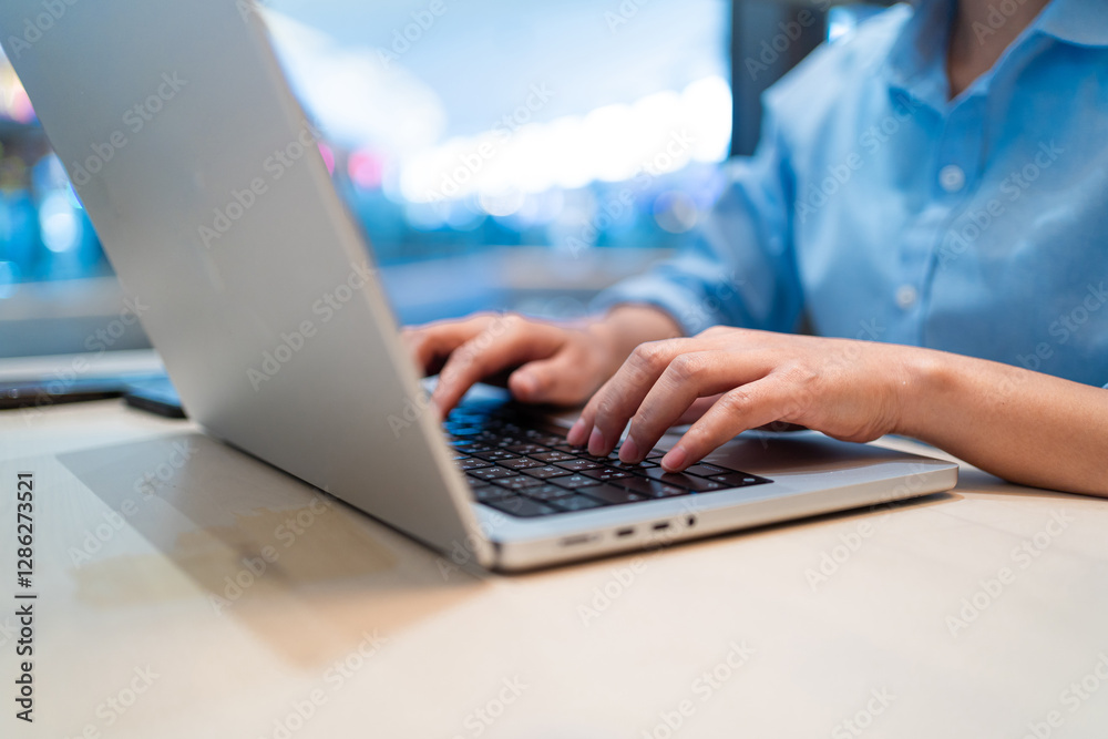 A woman is typing on a laptop computer. The laptop is open and the woman's hands are on the keyboard. Concept of productivity and focus as the woman works on her computer A woman is typing on a laptop computer. The laptop is open and the woman's hands are on the keyboard. Concept of productivity and focus as the woman works on her computer