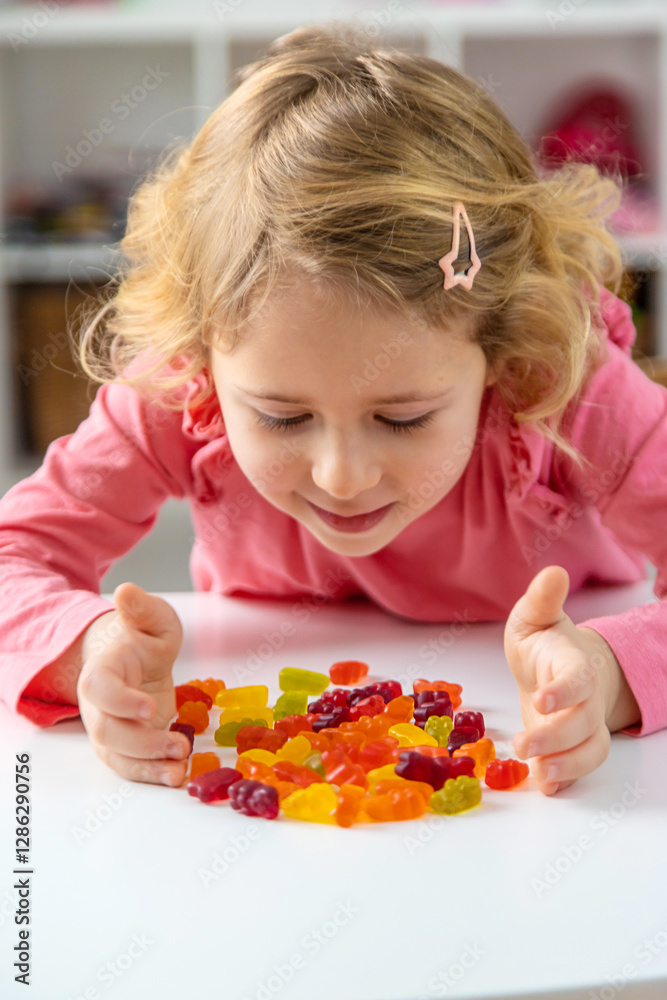 Child eating jelly candies at home. Selective focus. Child eating jelly candies at home. Selective focus.