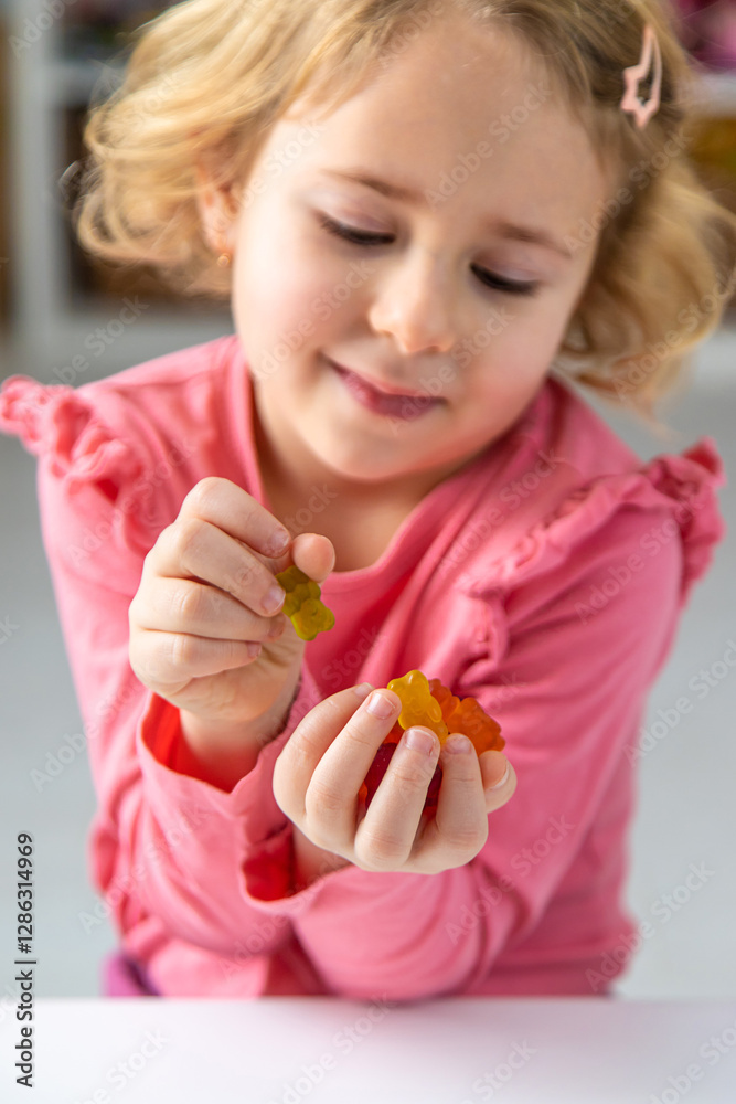 Child eating jelly candies at home. Selective focus. Child eating jelly candies at home. Selective focus.