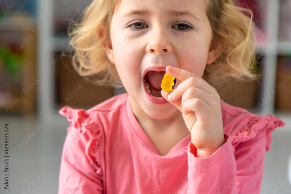 Child eating jelly candies at home. Selective focus. Child eating jelly candies at home. Selective focus.