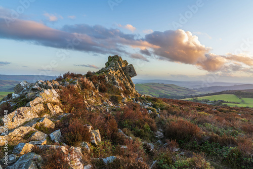 Landscape image of sunset colours at a rock formation on the Stiperstones National Nature Reserve in Shropshire in the UK photo