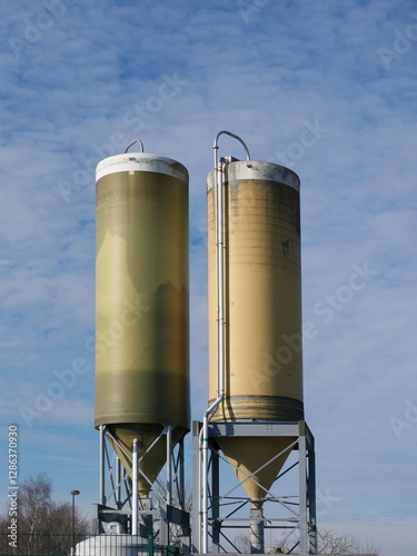 Salt silos in the industrial area ensure readiness for winter storms, storing deicing salt to maintain road safety during slipperiness and frost. photo