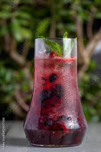 Refreshing summer drink with berries and mint in a glass. lemonade