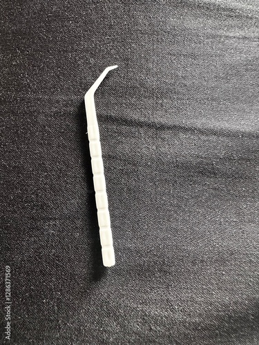 Plastic toothpick on black 