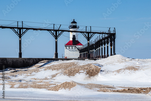 Dangerous Shelf Ice on Lake Michigan with the Michigan City Lighthouse in the background in winter. Michigan City, Indiana, USA  photo