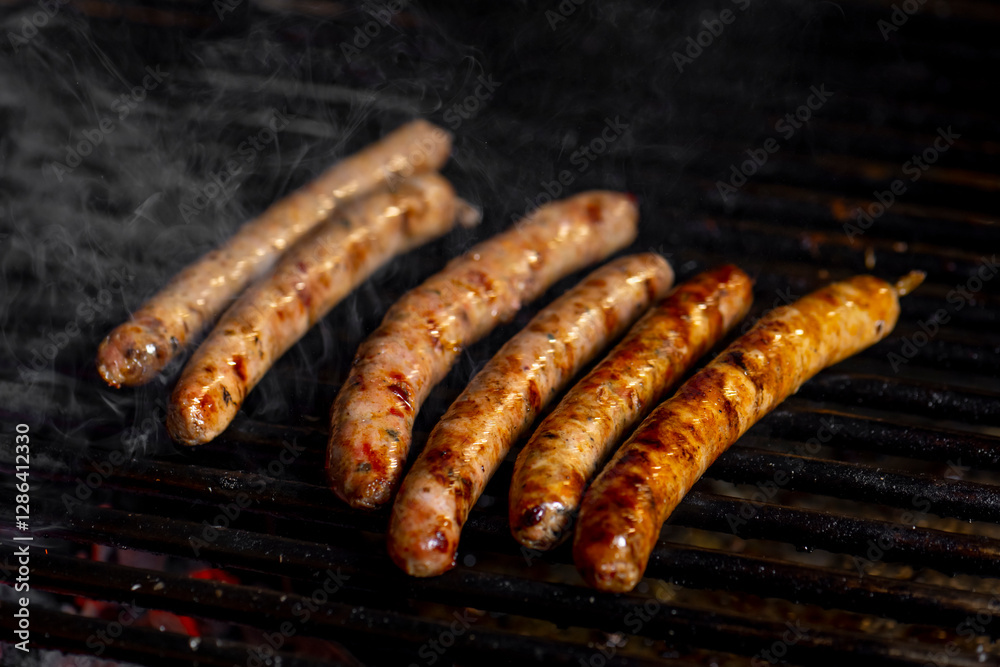 Grilling sausages on the grill with flames and smoke. Grilling sausages on the grill with flames and smoke.