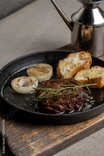 Grilled beef steak with rosemary and toasted baguette