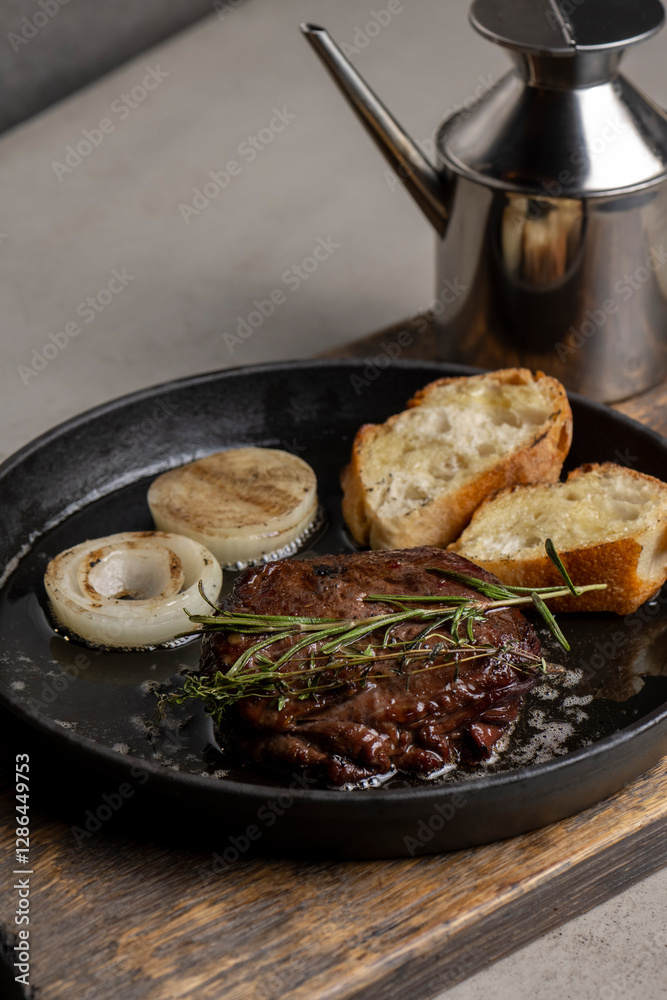 Fototapeta premium Grilled beef steak with rosemary and toasted baguette