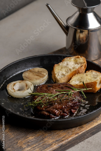 Grilled beef steak with rosemary and toasted baguette