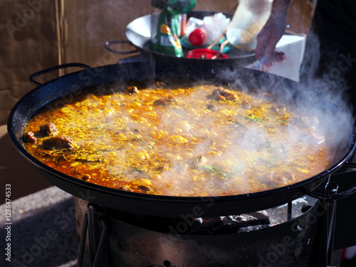 Wallpaper Mural Steaming Hot Traditional Spanish Paella Cooking Over an Open Fire in a Large Pan at Outdoor Market Torontodigital.ca