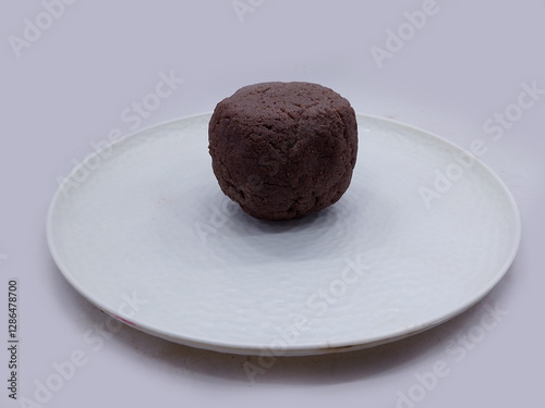 Deliciously Cooked Finger Millet Balls on a White Background. Nutritious Finger Millet Balls (Ragi Mudde) Served on a Clean White Background. Freshly Cooked Finger Millet Balls on a Minimalist White