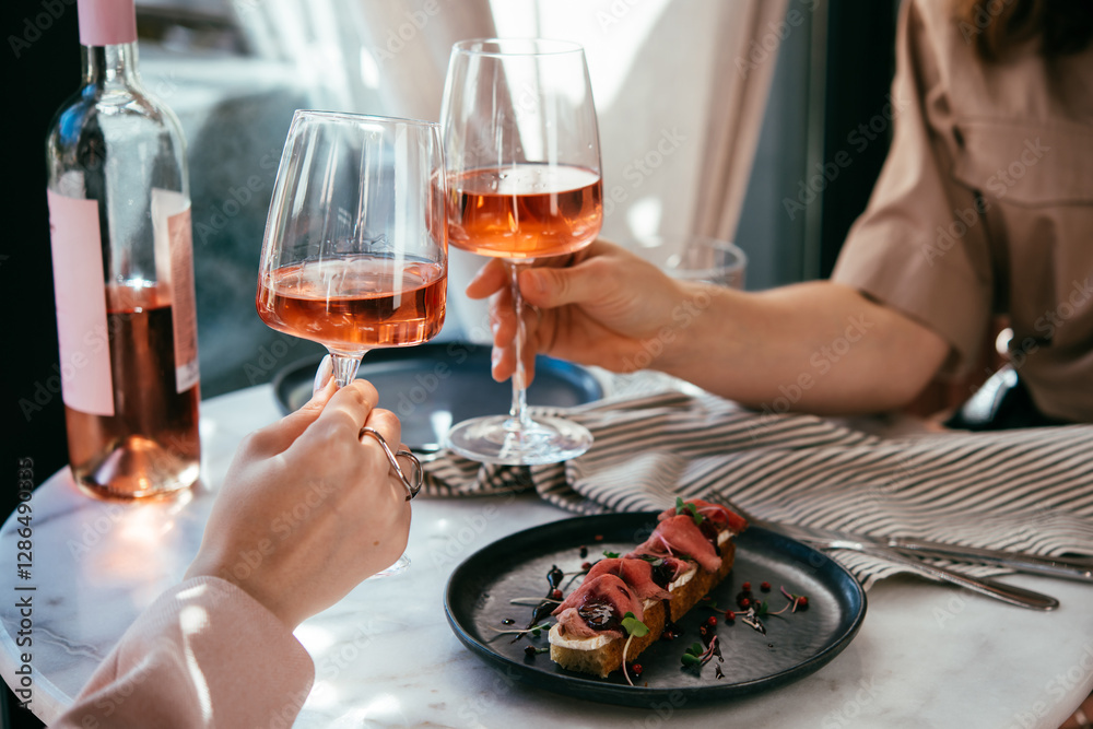 Glasses of rose wine seen during a friendly party or a celebration in a restaurant of a bar.
