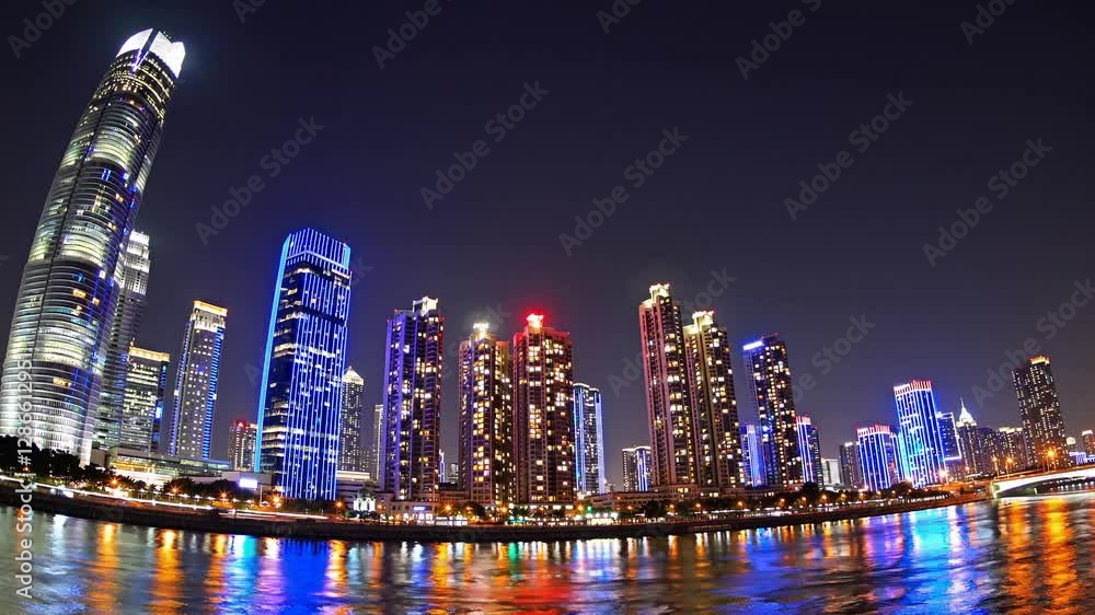 Cityscape at Night: A breathtaking cityscape at night, showcasing illuminated skyscrapers reflecting in the water, painting a vibrant picture of urban life and modernity. Cityscape at Night: A breathtaking cityscape at night, showcasing illuminated skyscrapers reflecting in the water, painting a vibrant picture of urban life and modernity.