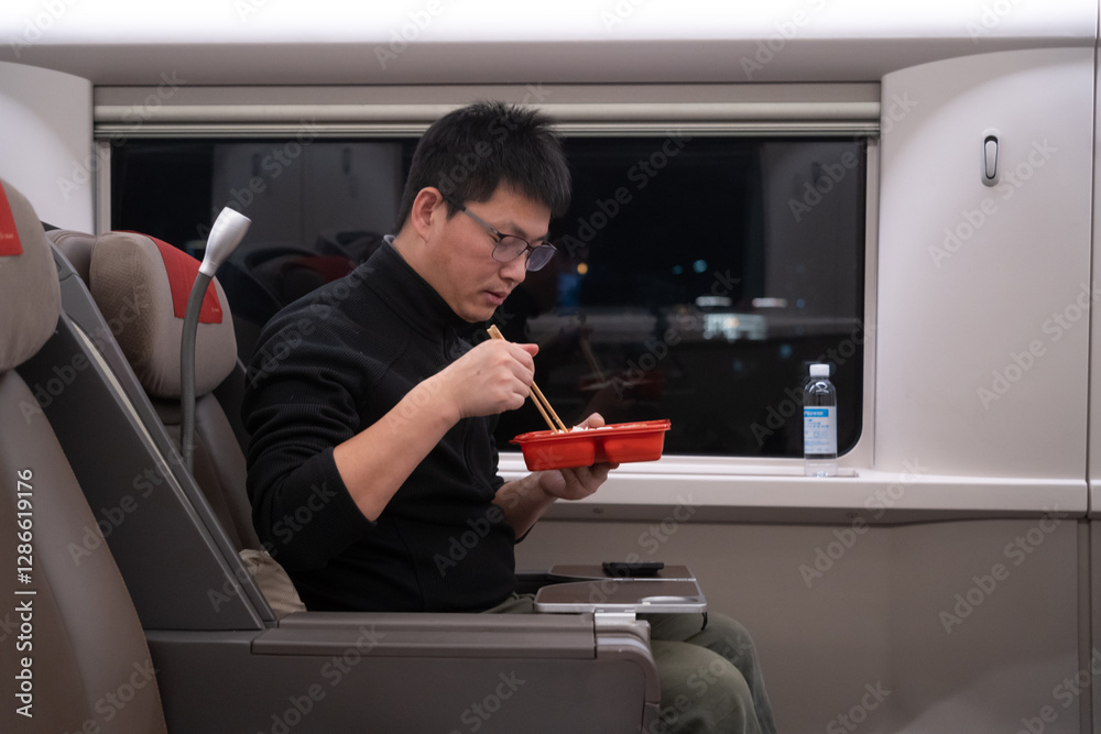 asian man eating in high speed train asian man eating in high speed train