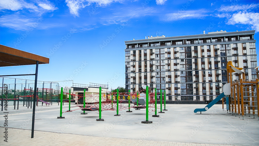 Playground with slides and swings on the background of an apartment building Playground with slides and swings on the background of an apartment building