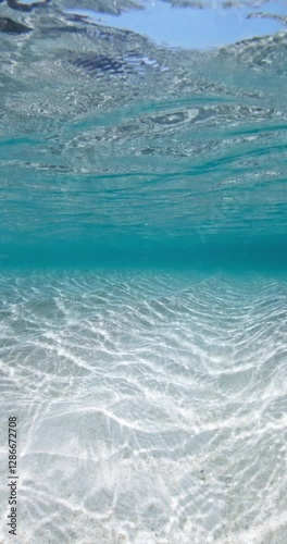 Turquoise ocean with white sand underwater, sea background with waves