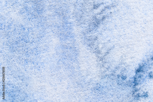 Close-up of blue textured canvas with soft patterns and abstract shadows creating a dreamy artistic background.