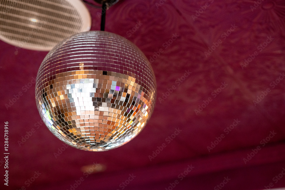 Obraz premium Glowing disco ball seen against ceiling