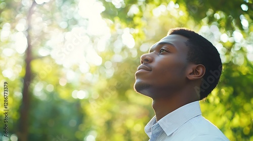 Obraz na płótnie Portrait dreamy young black man looking at infinity in a park Portrait dreamy young black man looking at infinity in a park businessman w salonie