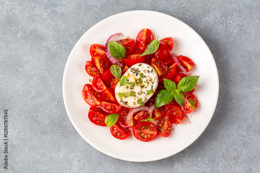 Italian caprese salad with sliced tomatoes, mozzarella, basil, olive oil