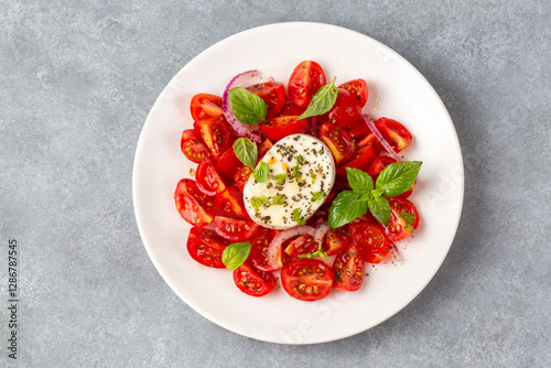 Italian caprese salad with sliced tomatoes, mozzarella, basil, olive oil