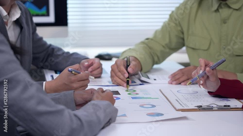 Strategic business team reviewing financial reports, analyzing performance charts, and engaging in collaborative discussions while planning corporate growth strategies