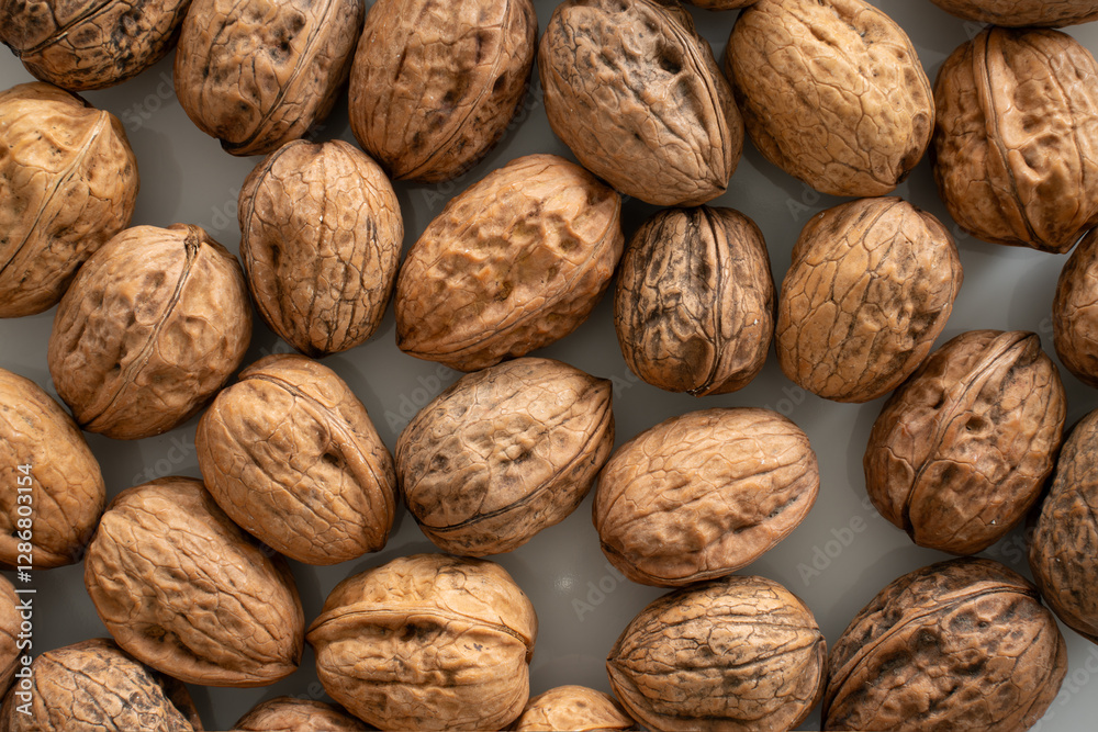 Closeup (macro) of walnuts on a white plate. Closeup (macro) of walnuts on a white plate.