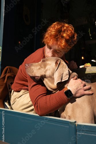 Beautiful love scene Young ginger haired boy and his dog. Owner and pet hugging and kissing