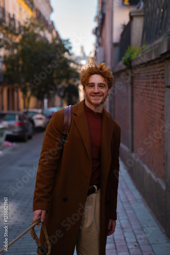 Young ginger hair walking down the street smiling looking at the camera
