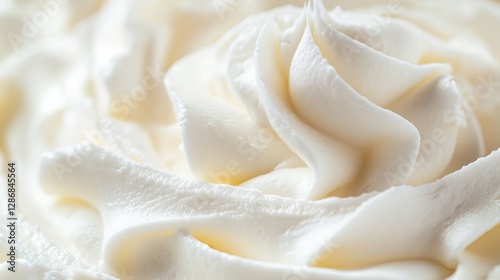 Close up of smooth white frosting on table, showcasing creamy texture for baking and decoration