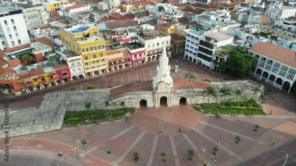 Drone footage of Monumento Torre del Reloj in Columbia with a view of colorful buildings in the city