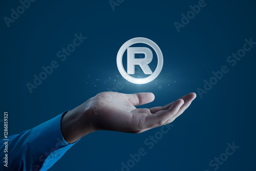 Human Hand Holding R Registered Trademark Symbol for Branding and Legal Concepts