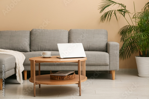 Remote work and home office setup, laptop on coffee table with cup of coffee ...