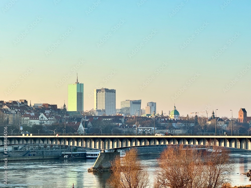 view of a bank of the vistula in the city of warsaw with a bridge and buildings at sunset
view of a bank of the vistula in the city of warsaw with a bridge and buildings at sunset