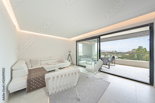 a luxury illuminated living room with leather chairs in mediterranean holiday home