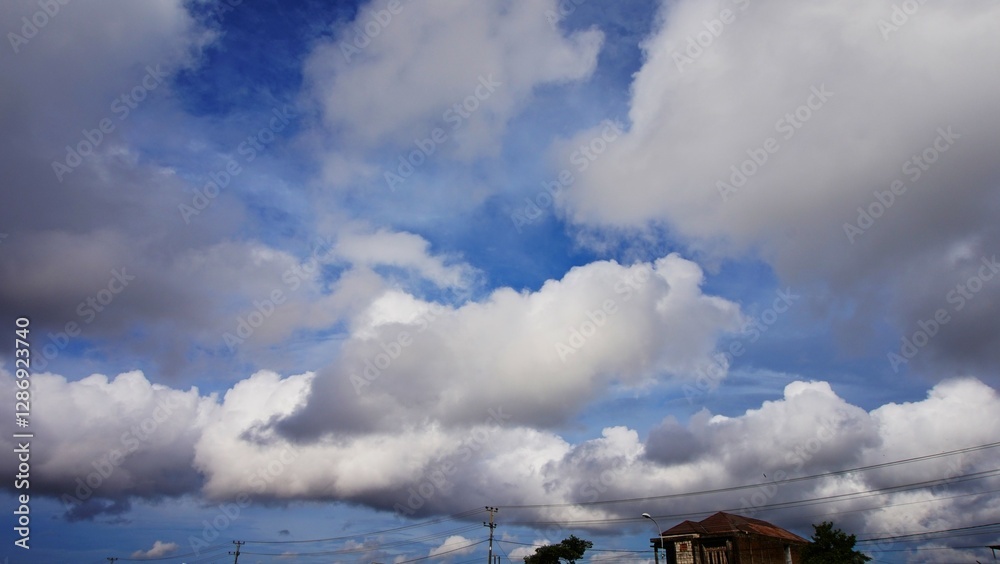 Obraz premium clear blue sky with beautiful white clouds, and tall tower tops. suitable for background