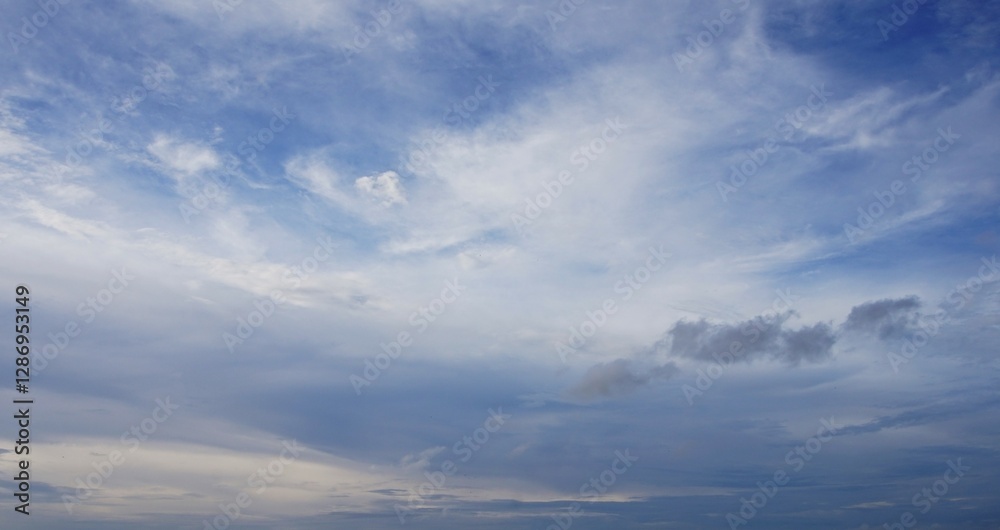 The clear afternoon sky with beautiful white clouds, looks natural, suitable for a background The clear afternoon sky with beautiful white clouds, looks natural, suitable for a background
