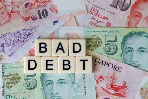 Bad debt signage on background o Simgaporean dpllars.