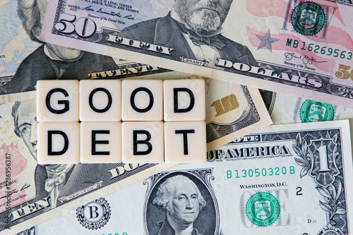 Good debt signage on a bed of American dollars.