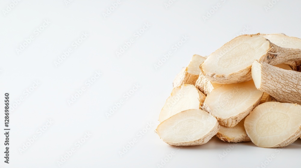 A close-up view of stacked, cut slices of a root vegetable, showcasing their natural texture and color against a neutral background. A close-up view of stacked, cut slices of a root vegetable, showcasing their natural texture and color against a neutral background.