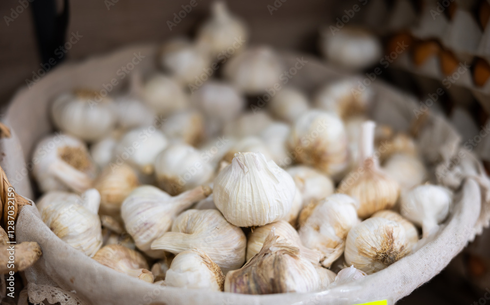 Garlic in basket on counter in market closeup Garlic in basket on counter in market closeup