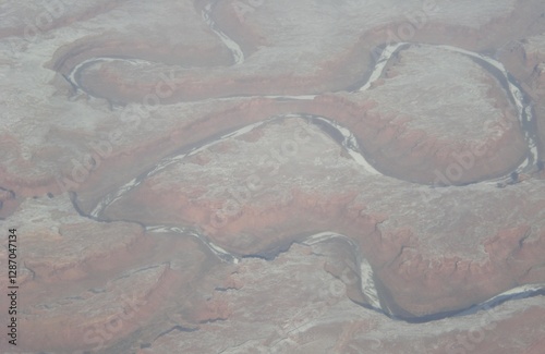 a winding canyon formed in the mountains creating deep slopes which turn into a winding river