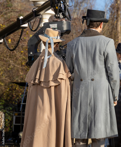 Two men in period costumes stand next to each other