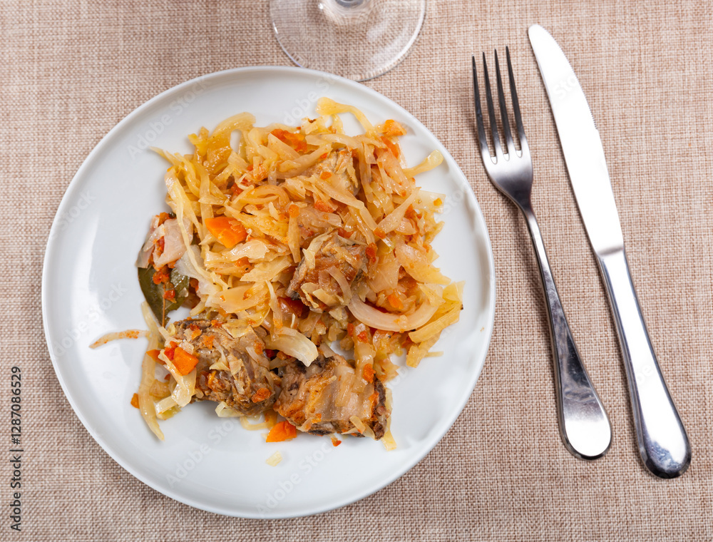 Appetizing stewed pork ribs served on platter with cabbage.. Appetizing stewed pork ribs served on platter with cabbage..