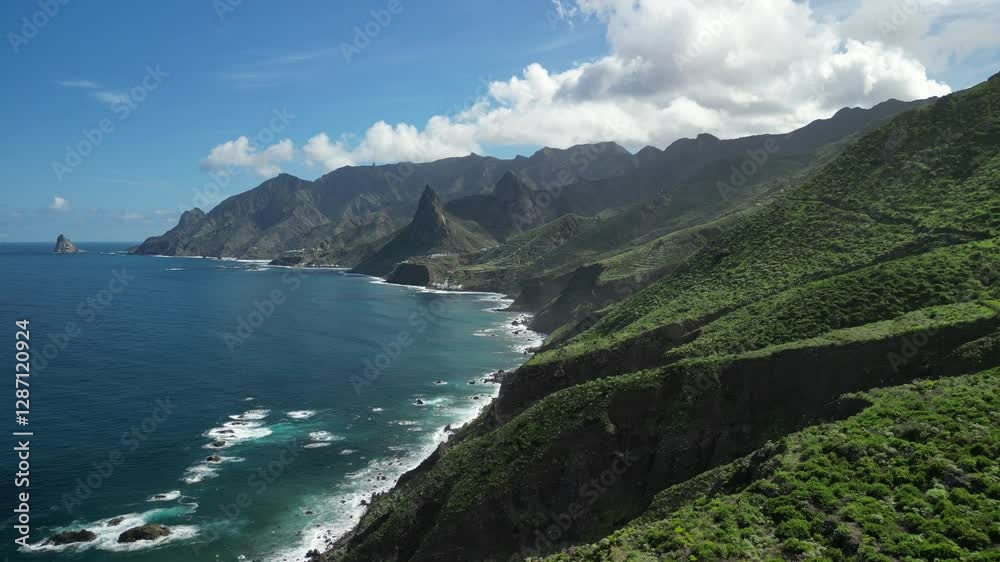Stunning aerial view of dramatic cliffs and turquoise ocean on a sunny day. Lush green mountains meet the coastline in this breathtaking landscape. Perfect for travel, nature, and adventure projects. Stunning aerial view of dramatic cliffs and turquoise ocean on a sunny day. Lush green mountains meet the coastline in this breathtaking landscape. Perfect for travel, nature, and adventure projects.