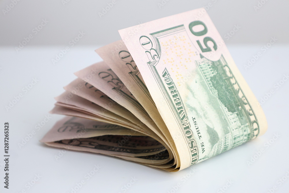 a stack of fifty dollar bills lies unfolded on the table a stack of fifty dollar bills lies unfolded on the table