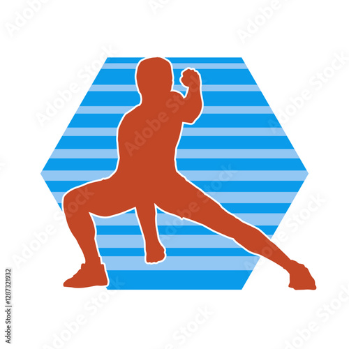 Silhouette of a sporty male in action pose at the gym. Silhouette of a slim man in aerobics workout pose.