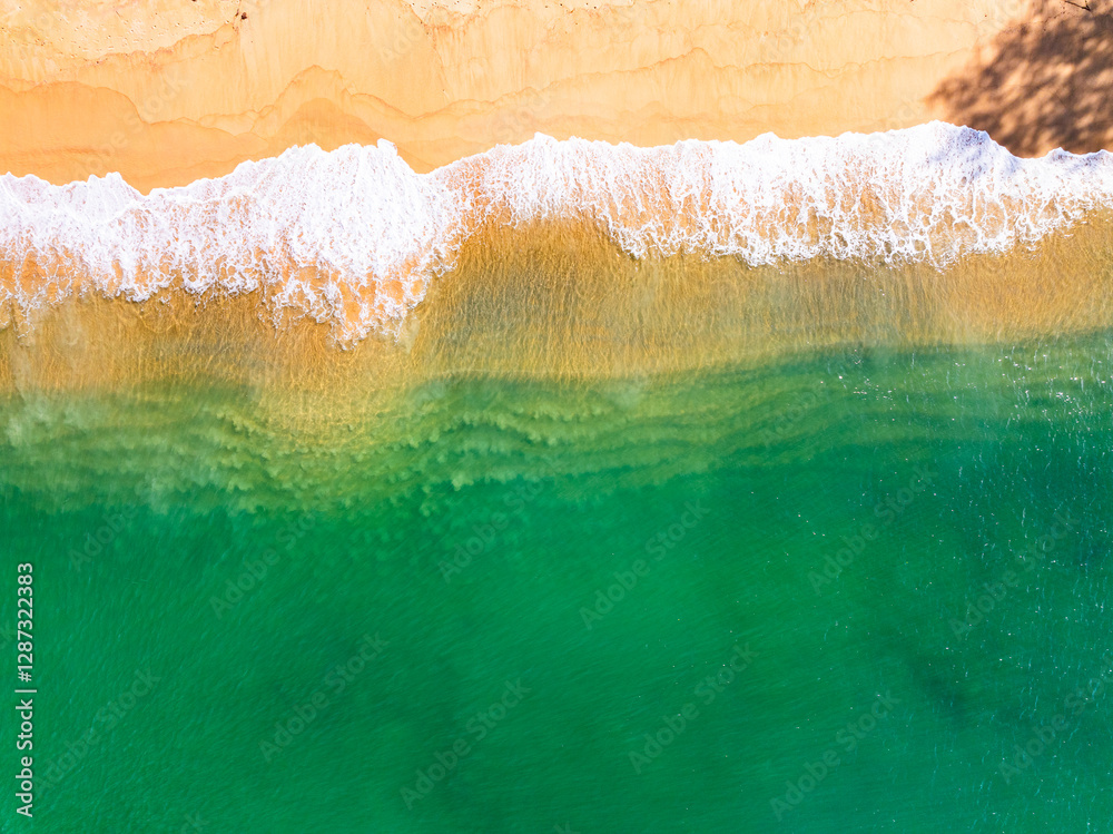 Fototapeta premium Summer seascape beautiful waves,Tropical sea water in sunny day, Top view from drone camera,Amazing ocean colorful nature background, Beautiful bright sea waves splashing on beach sand
