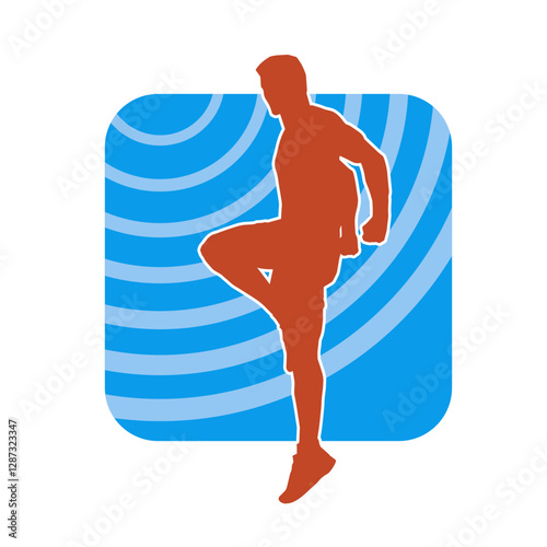 Silhouette of a sporty male in action pose at the gym. Silhouette of a slim man in aerobics workout pose.