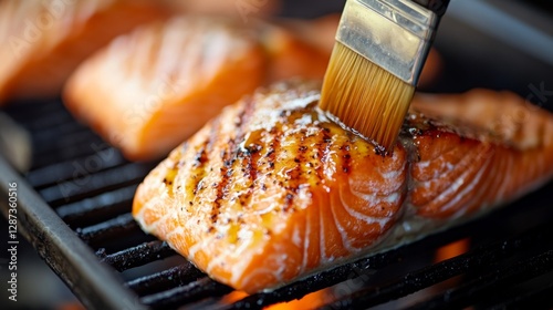 Brushing fresh salmon fillet kitchen food photography culinary close-up flavor enhancement photo